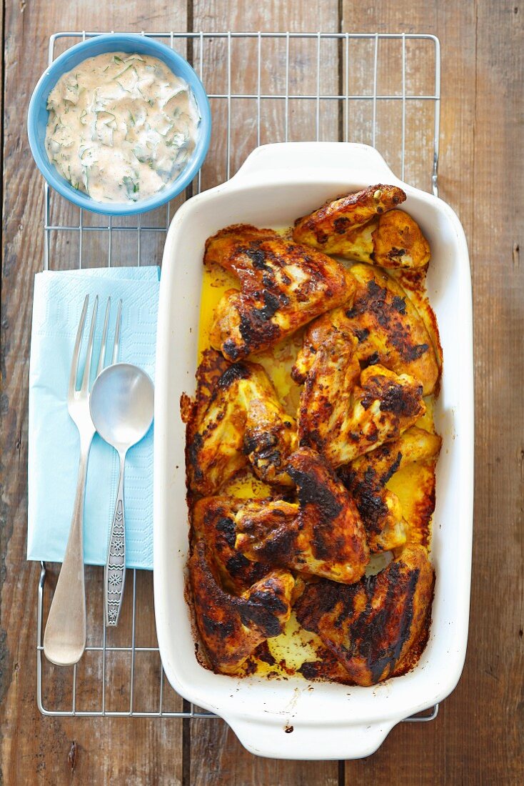 Chicken wings in a curry-yoghurt marinade with a yoghurt dip