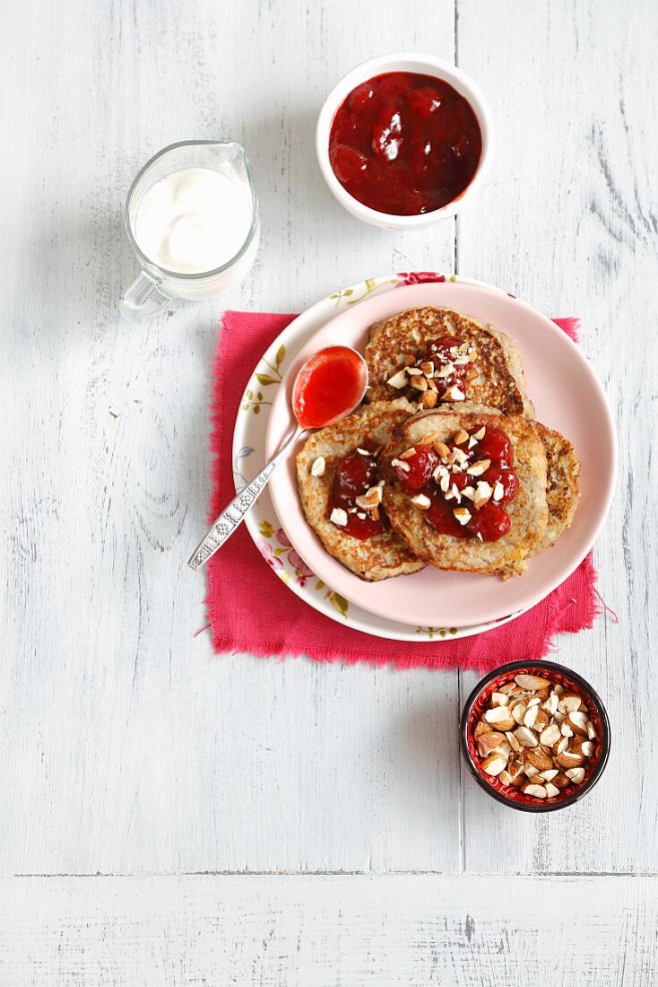Couscous pancakes with bananas, strawberry jam and almonds