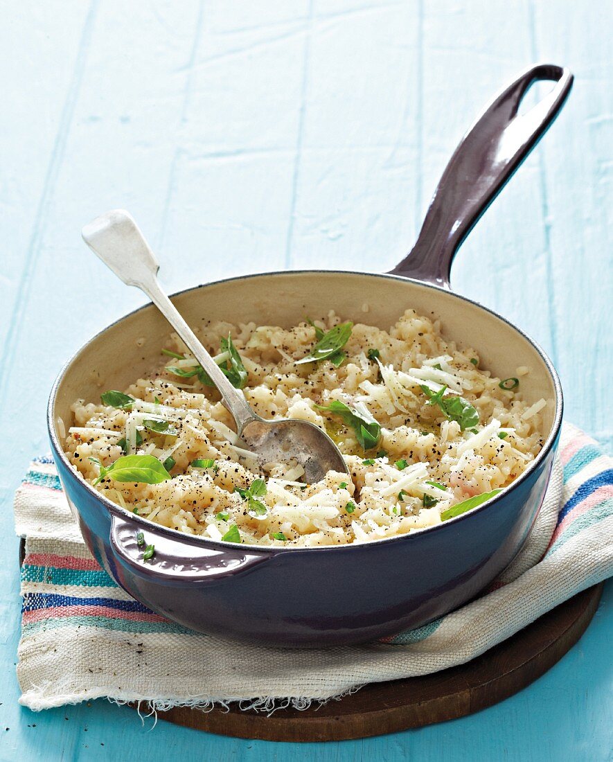 Risotto with fresh basil in a pan