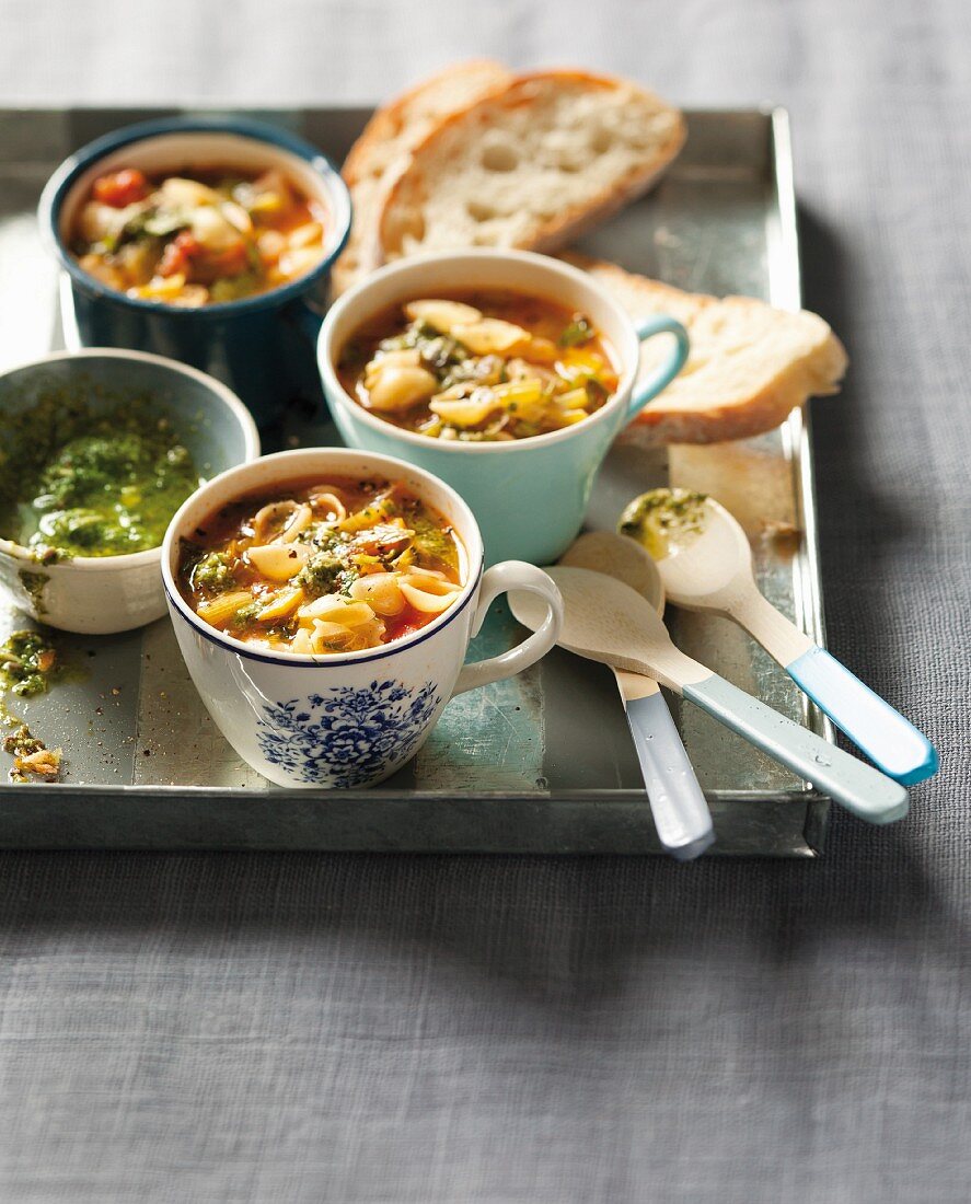 Minestrone with pasta and pesto in soup bowls