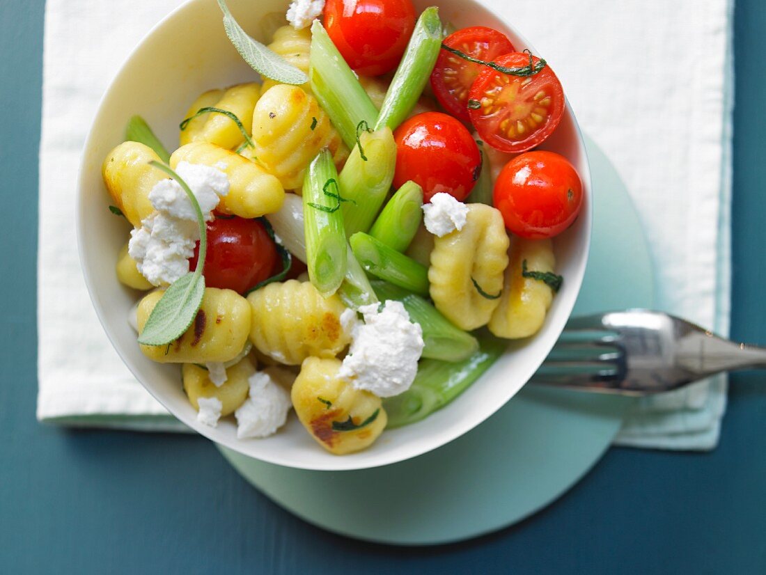 Gnocchi with cherry tomatoes, spring onions and rocket