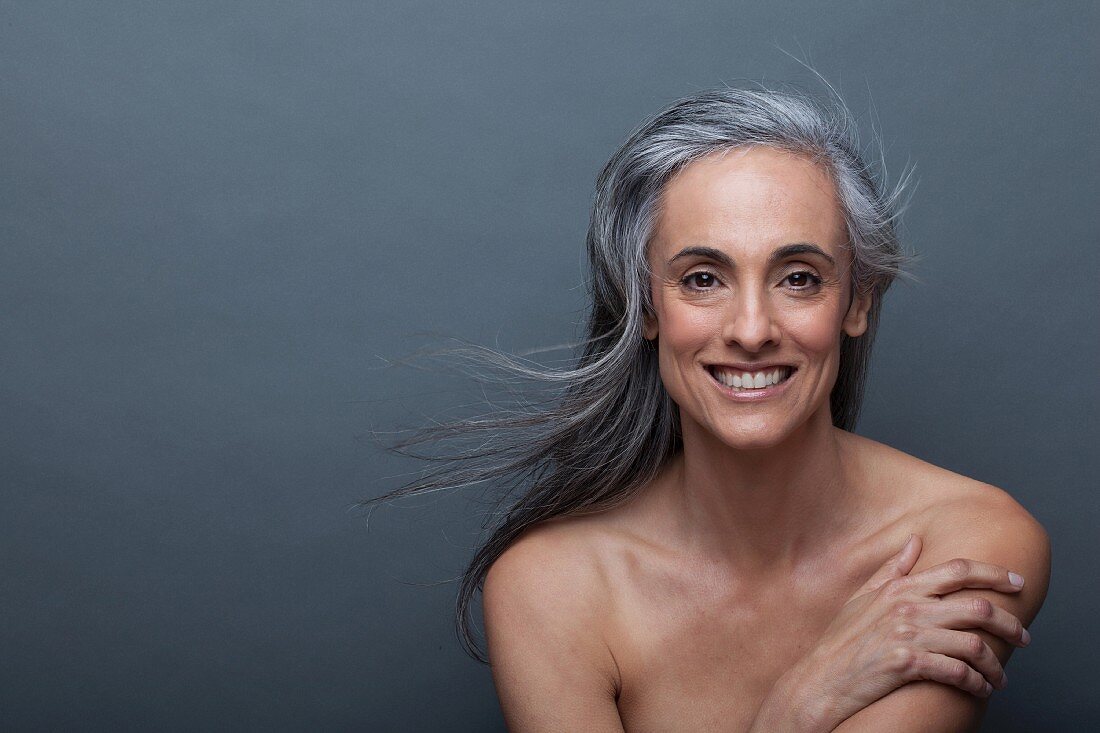 A portrait of an older woman with flowing grey hair