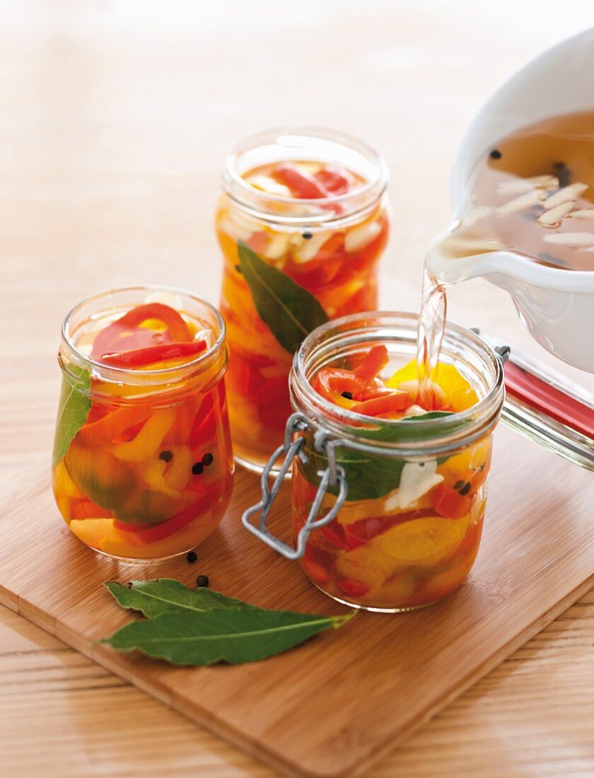 Pickled red and yellow pepper in preserving jars