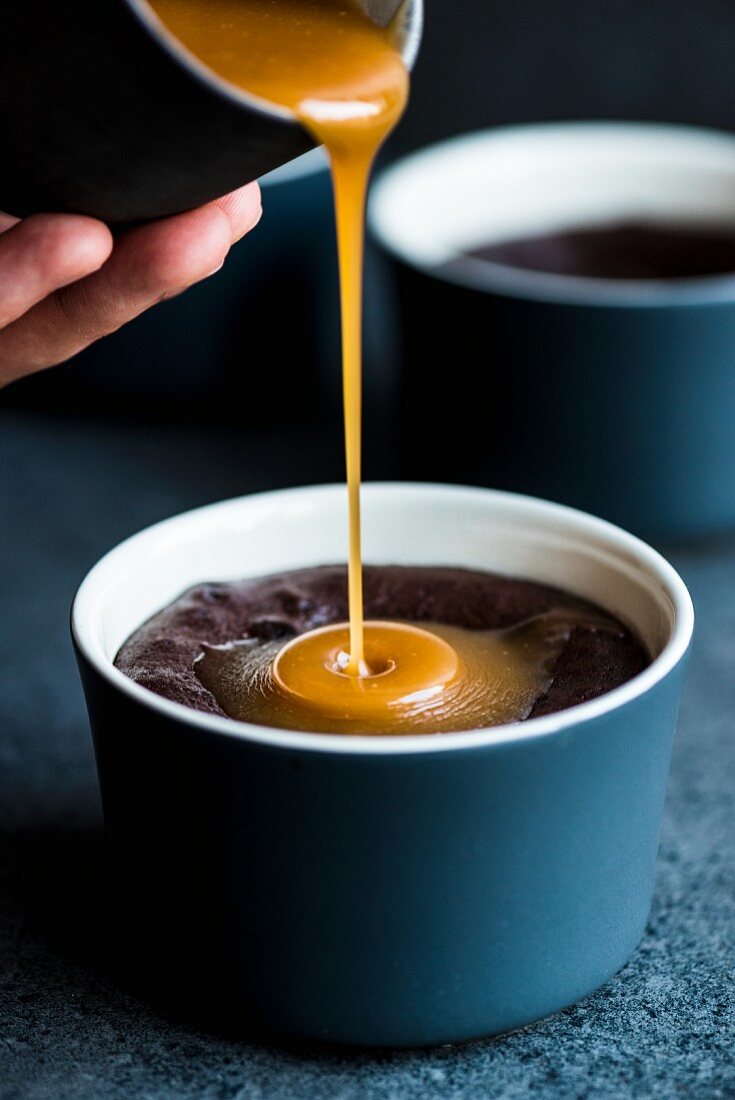 Caramel sauce flowing onto molten chocolate pudding