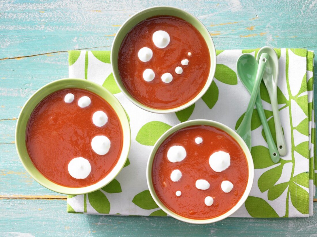 Orange and tomato soup with cream rosettes