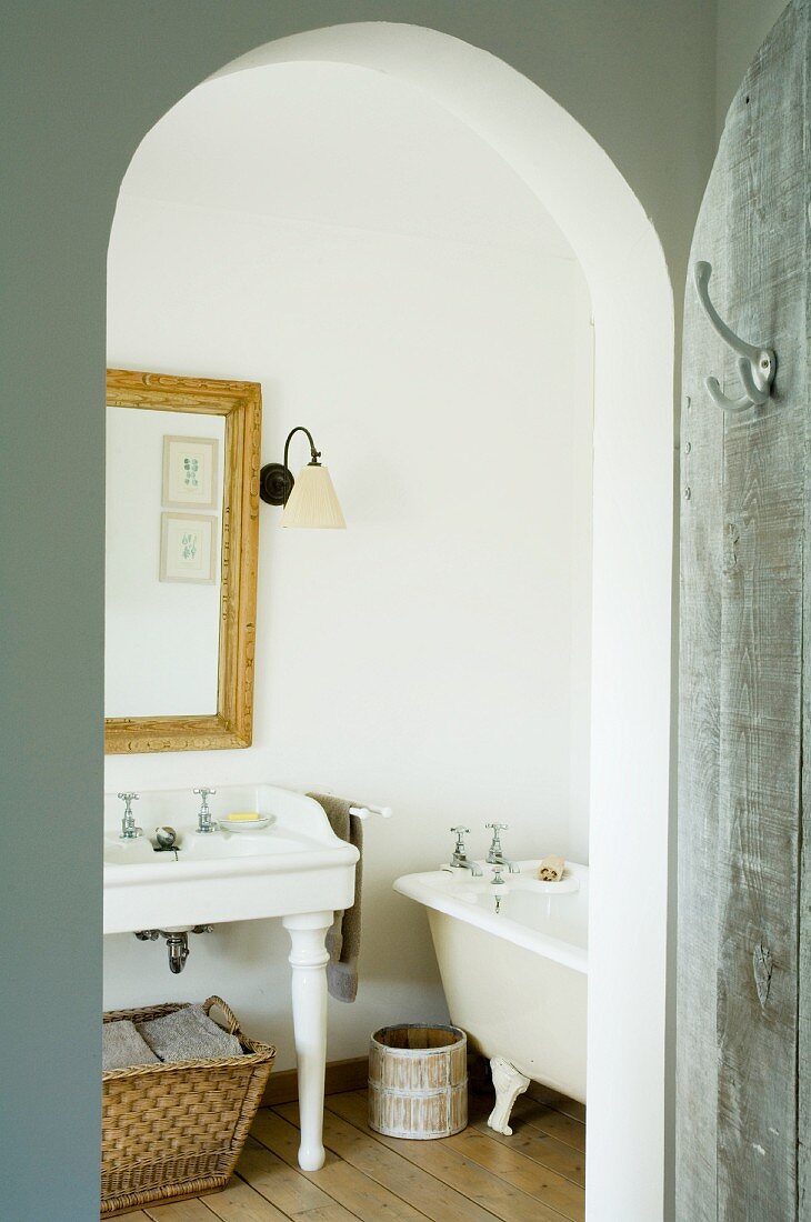 View into bathroom through arched doorway