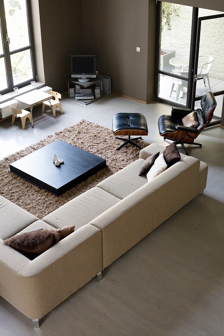 Modern living room in shades of brown with open terrace doors