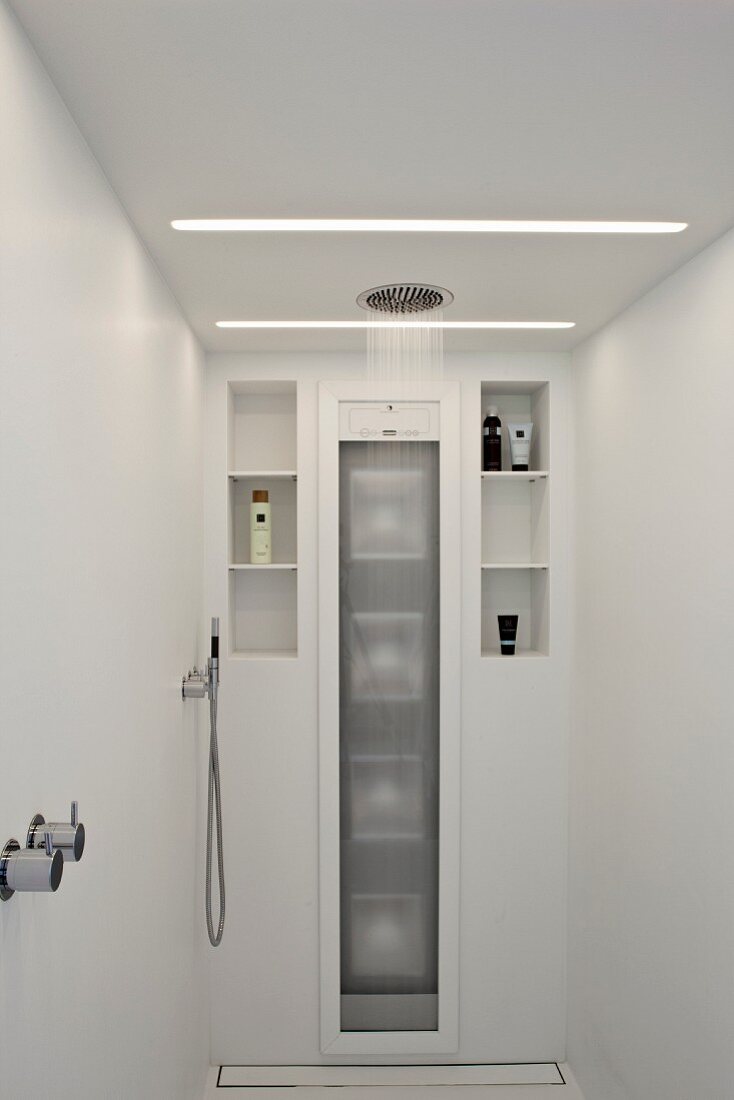 Rainfall shower in white designer bathroom