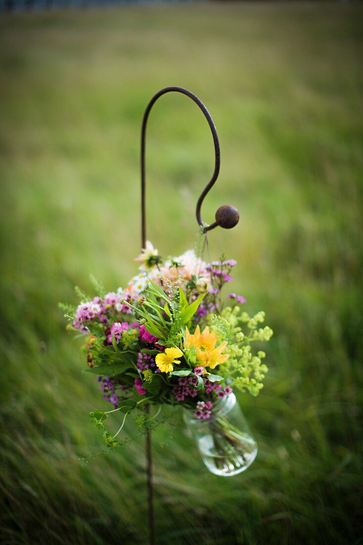 A bouquet hanging in a glass jar
