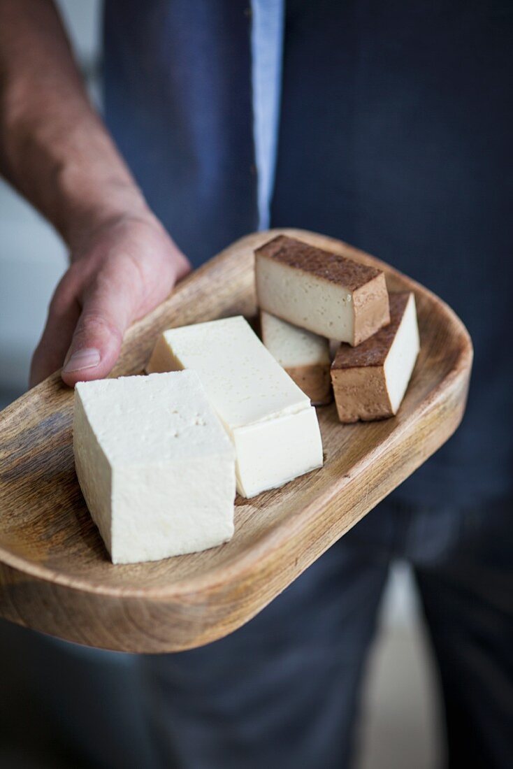 Natural tofu and smoked tofu on a wooden board