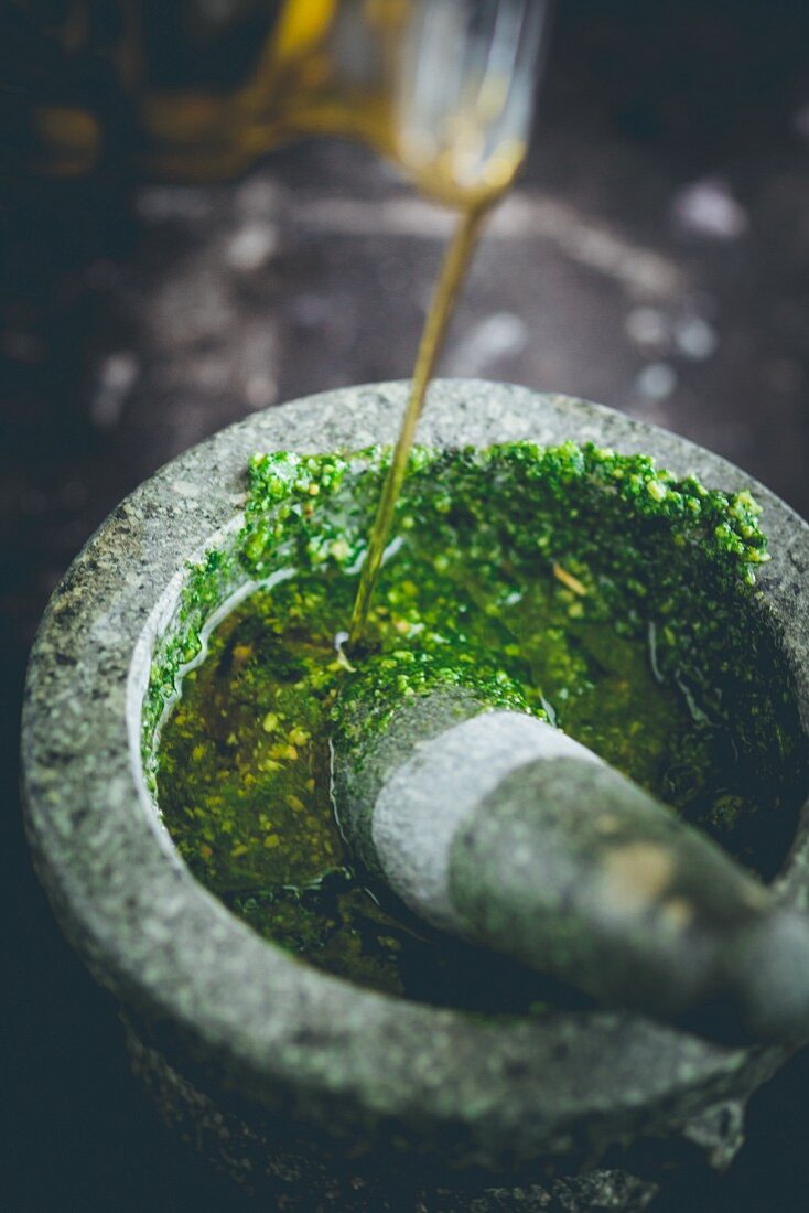 Wild garlic pesto being made with a pestle and mortar