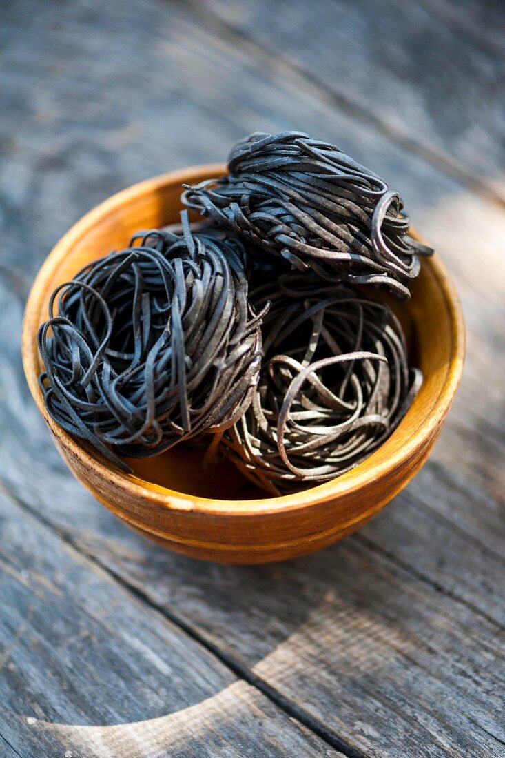 Pasta nests made of black sepia pasta in a bowl