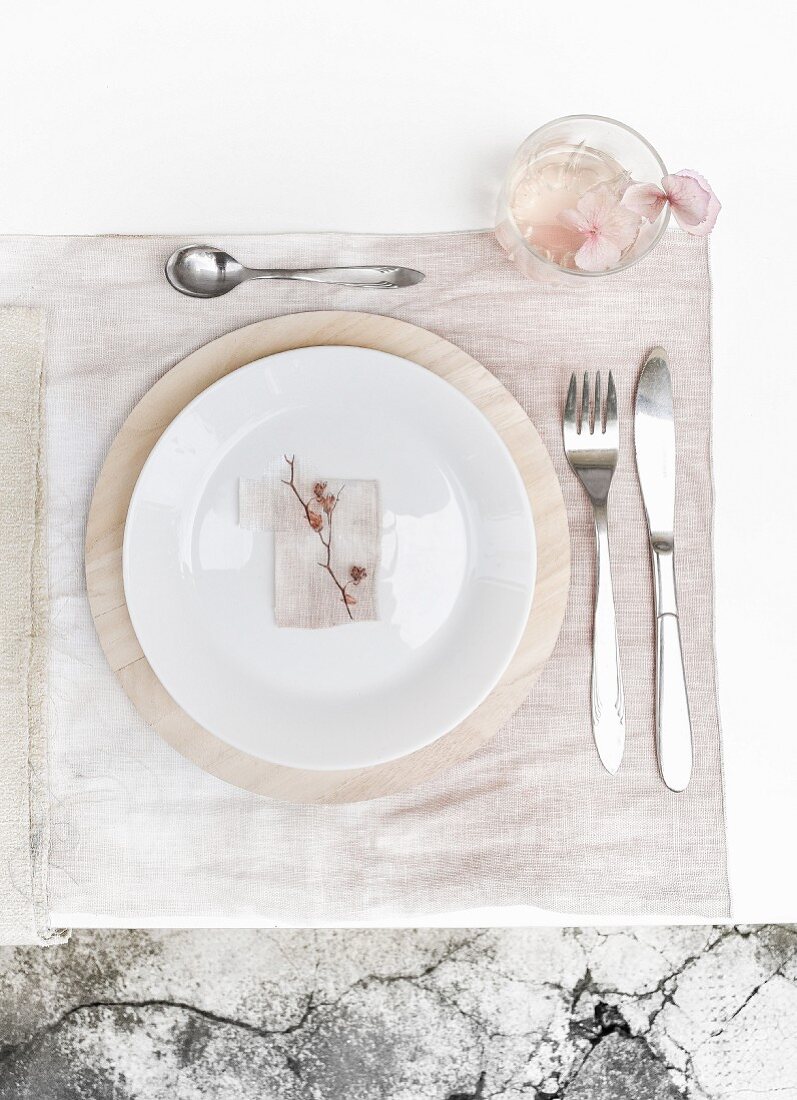 Place setting on pale pink place mat dyed using hydrangea flowers