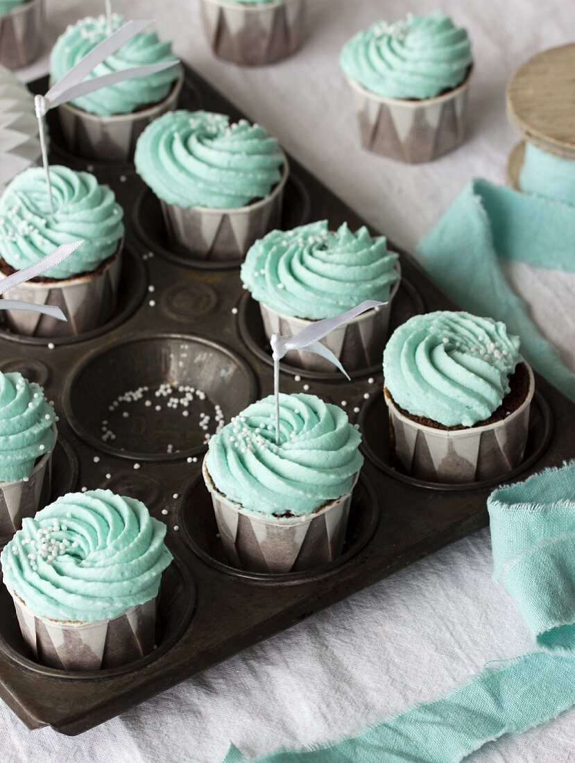 Chocolate cupcakes with mint-coloured frosting