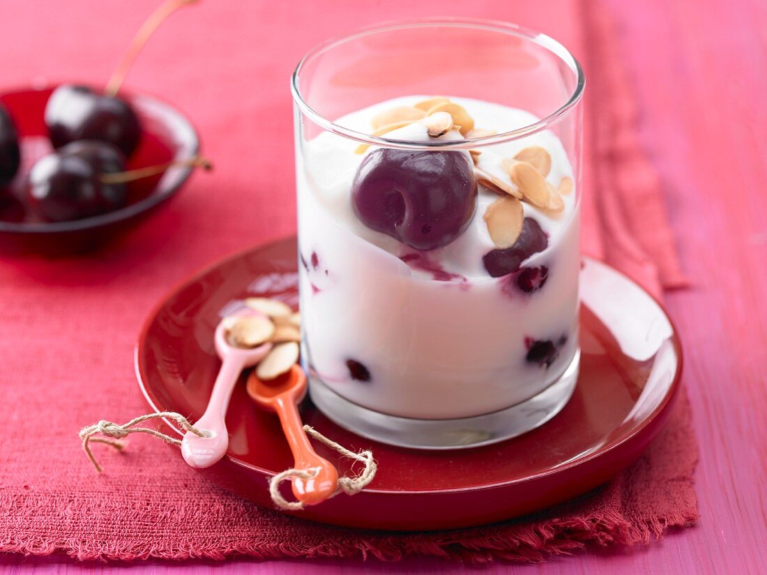 Orange yoghurt with cherries and almonds