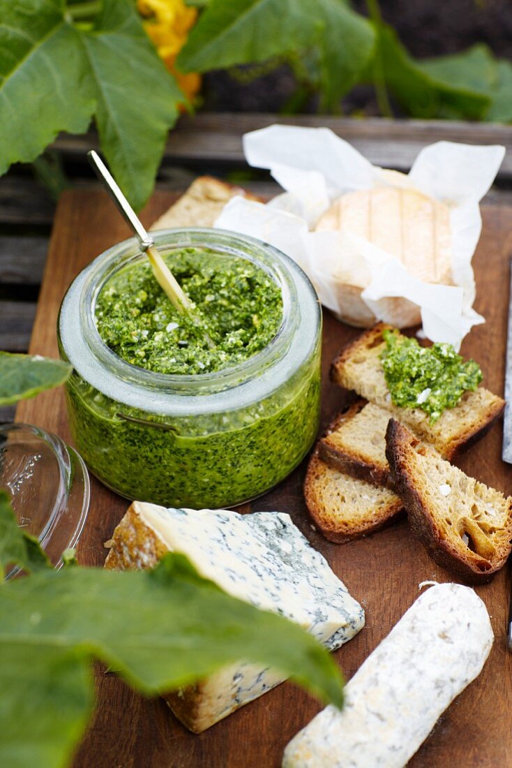 Pesto in a glass with bread and cheese