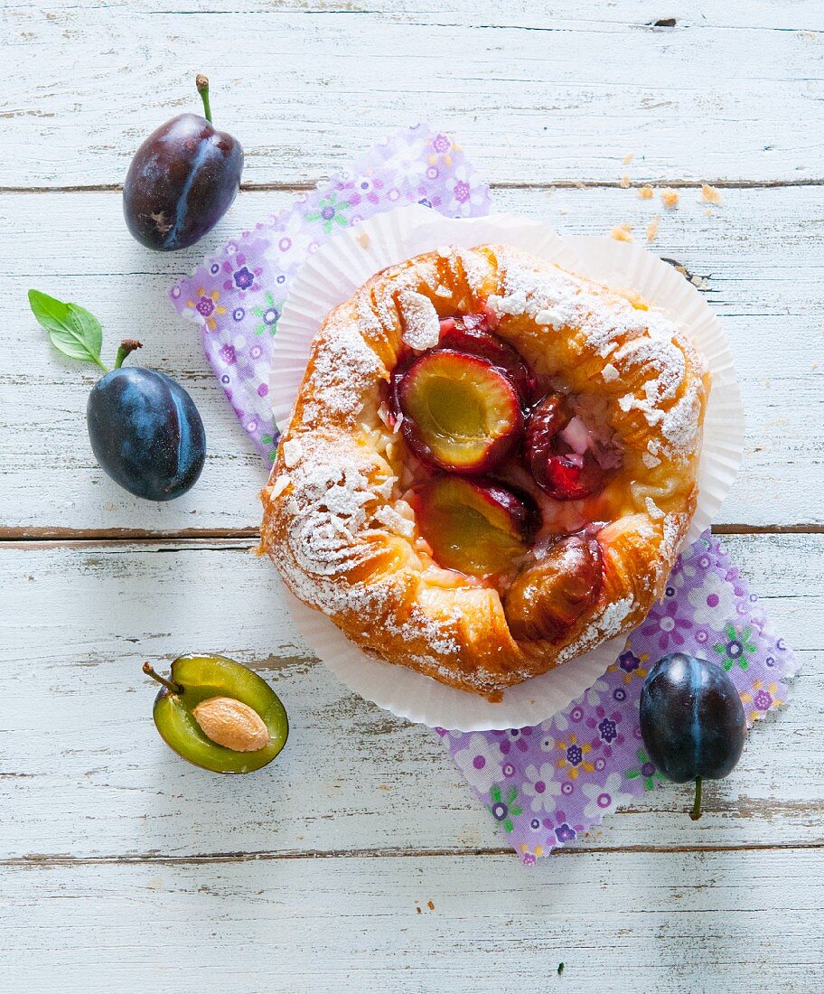 A Danish pastry with plums (seen from above)