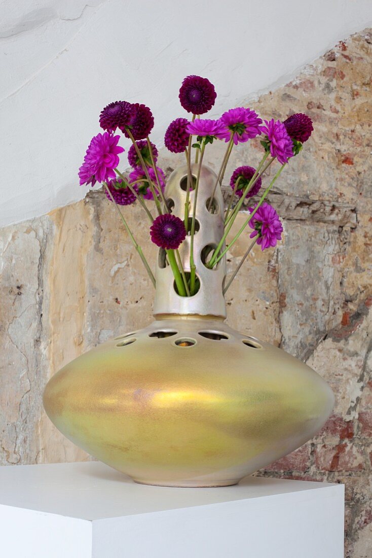 Purple dahlias in designer vase