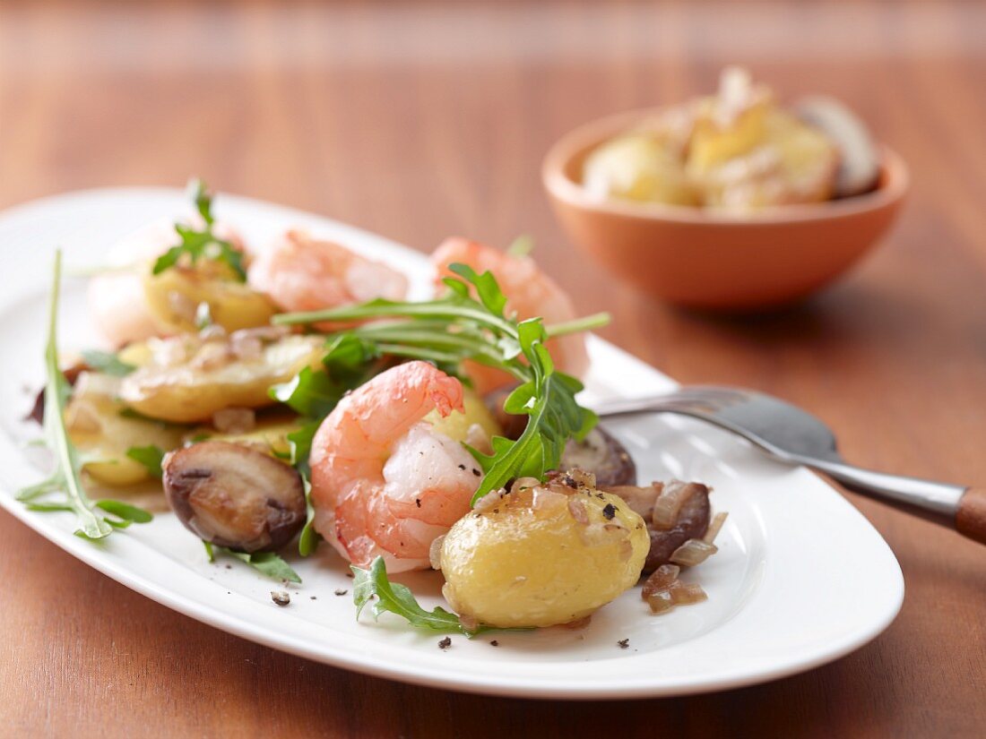 Fried potatoes with mushrooms and prawns