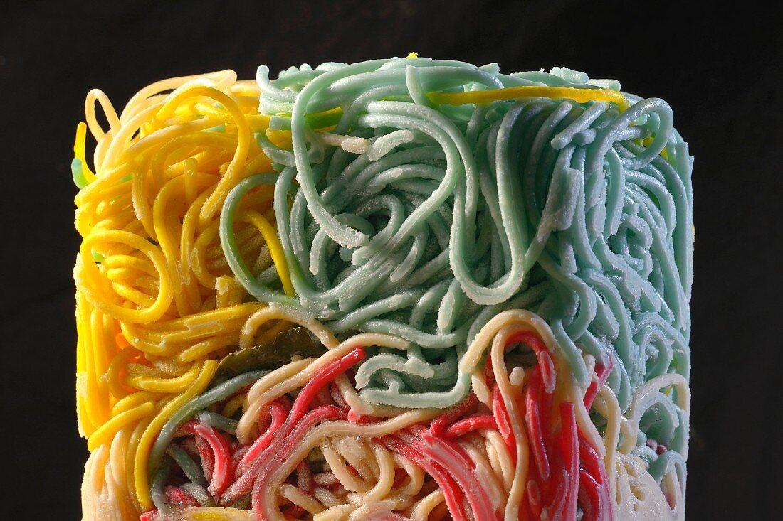 Colourful spaghetti frozen into a block