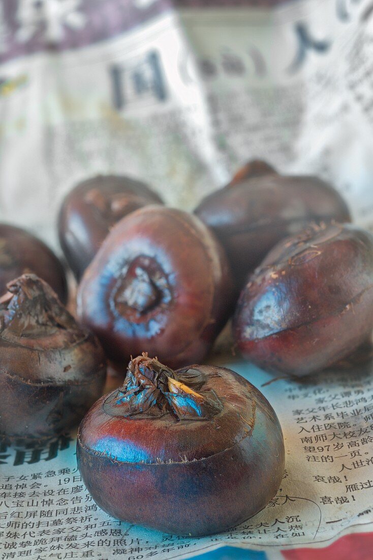 Water chestnuts on newspaper