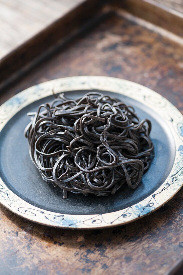 Black squid ink pasta on a plate