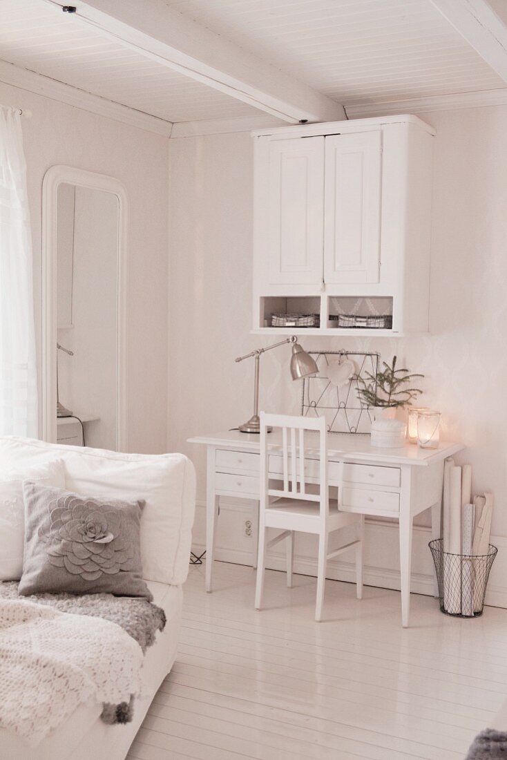 White work area with wall-mounted cabinet above desk