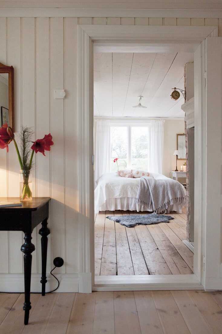 View from hallway into Scandinavian country-house-style bedroom