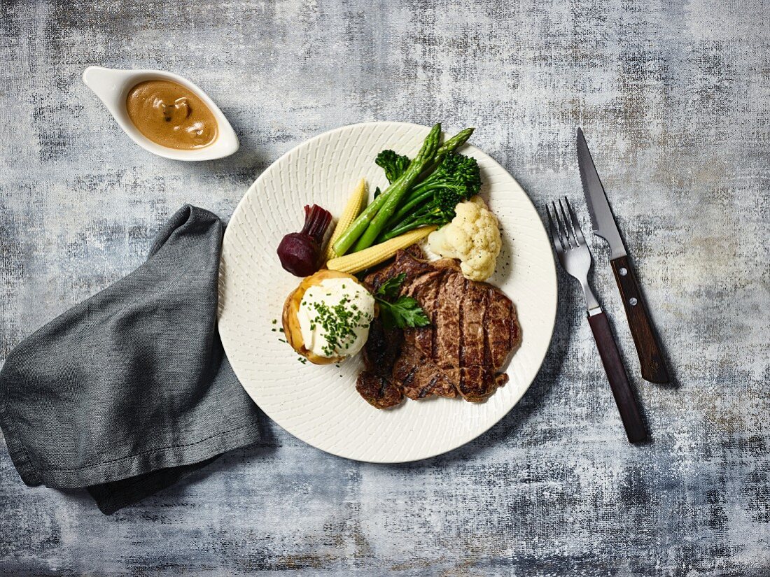 Beef steak with baked potato and vegetables