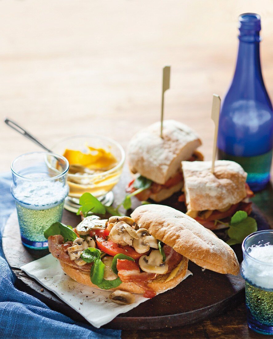 Sandwiches with mushrooms, bacon, tomato and watercress