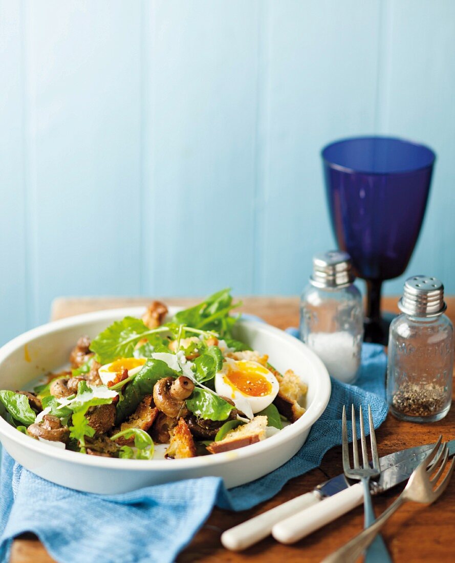 Mushroom salad with eggs, rocket and croutons