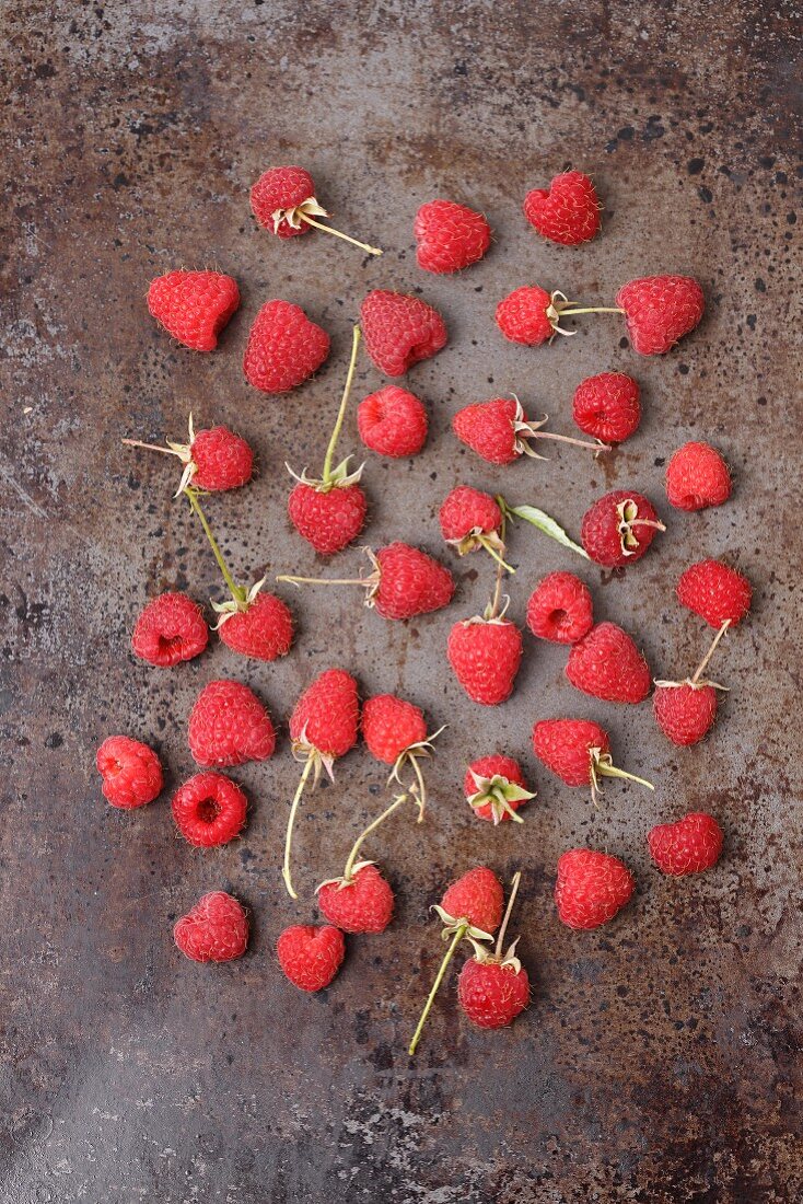 Fresh raspberries on a metal surface (seen from above)