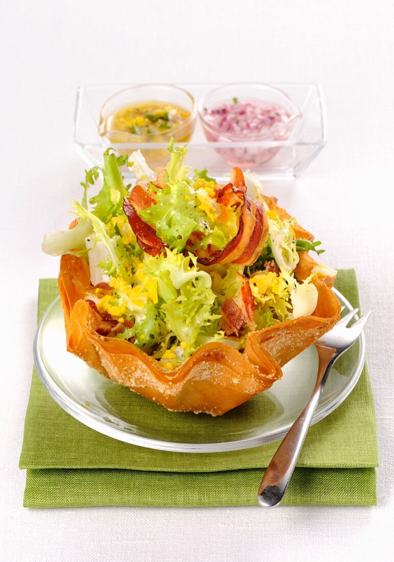 Frisee lettuce salad with bacon and egg