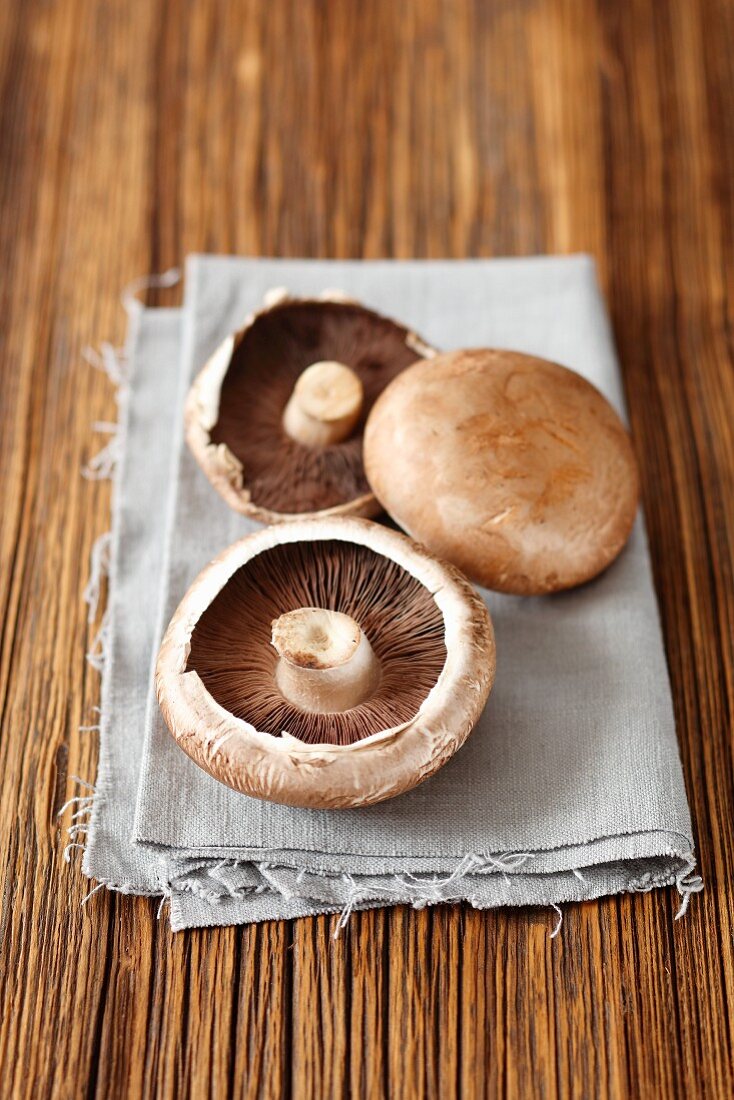 Fresh portobello mushrooms on a towel