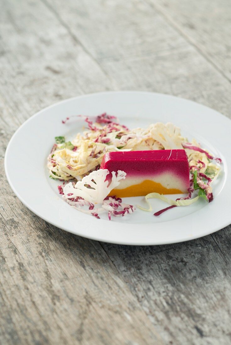 A three-coloured vegan vegetable terrine with beetroot, cauliflower and carrots