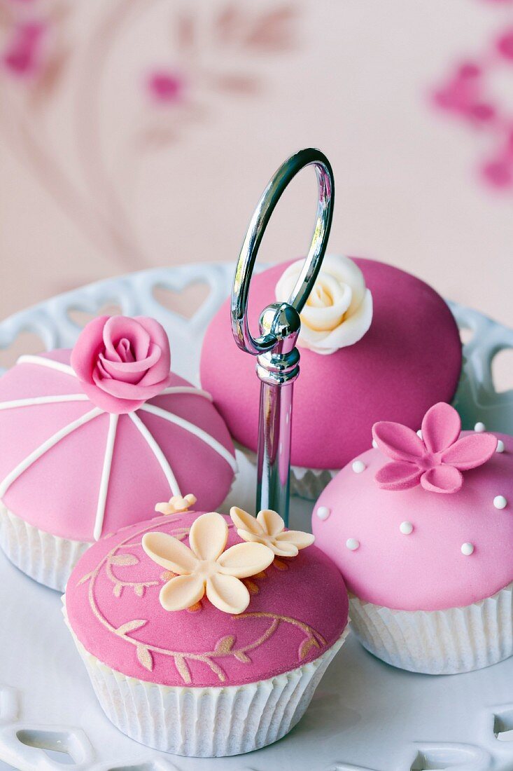 Gourmet cupcakes decorated with fondant and sugar flowers