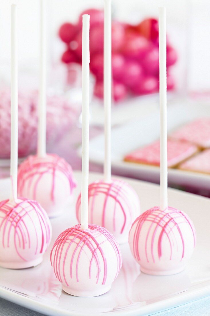 White cake pops with pink decorations