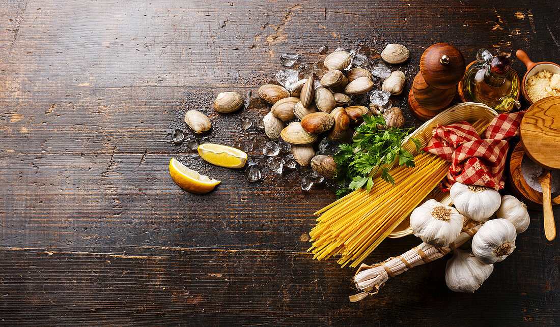 Dark wooden background with Ingredients for cooking Spaghetti vongole