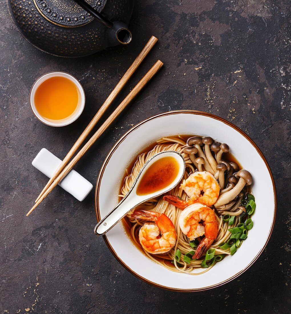 Asian Ramen noodles with prawns, shimidzhi mushrooms and green onions in broth