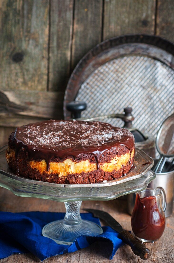 A chocolate cake with a coconut filling and ganache