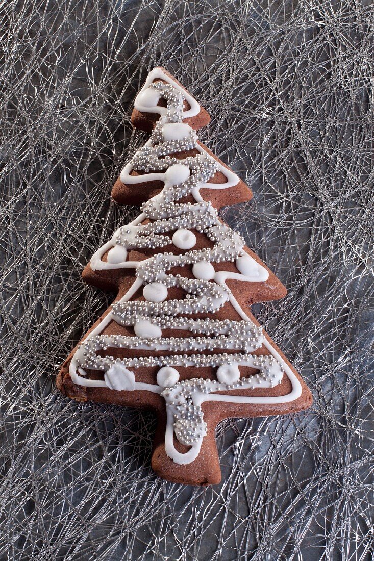 A Christmas gingerbread biscuit in the shape of a Christmas tree