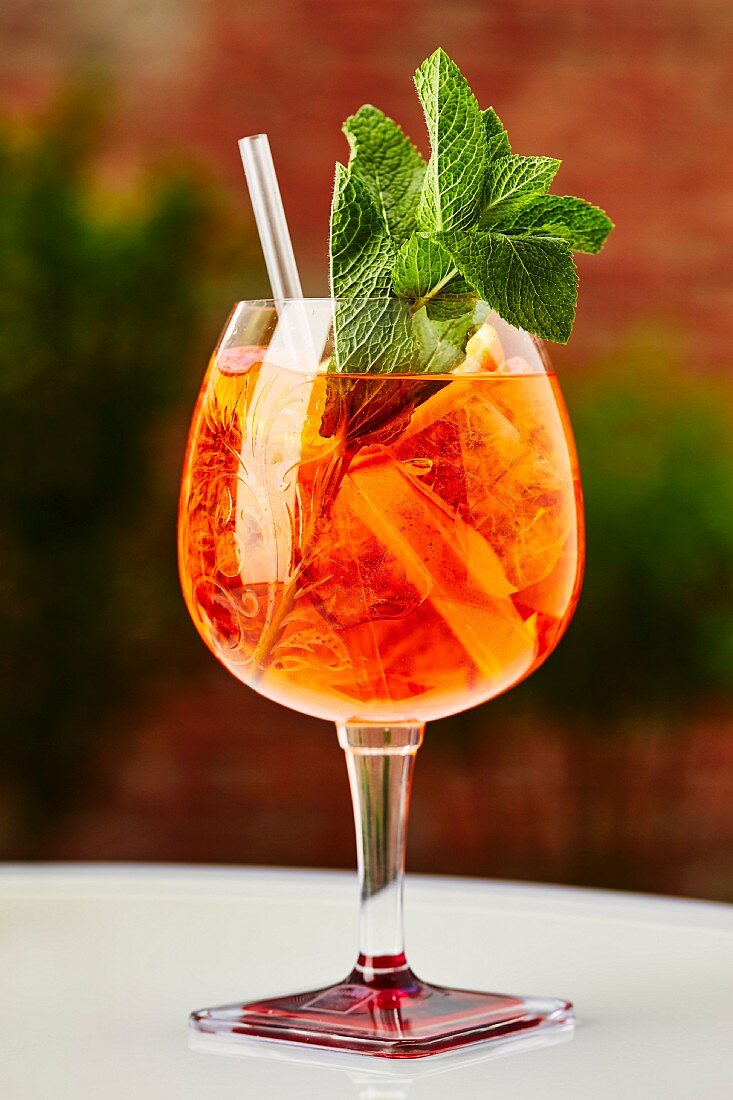 A cocktail with Aperol and fresh mint