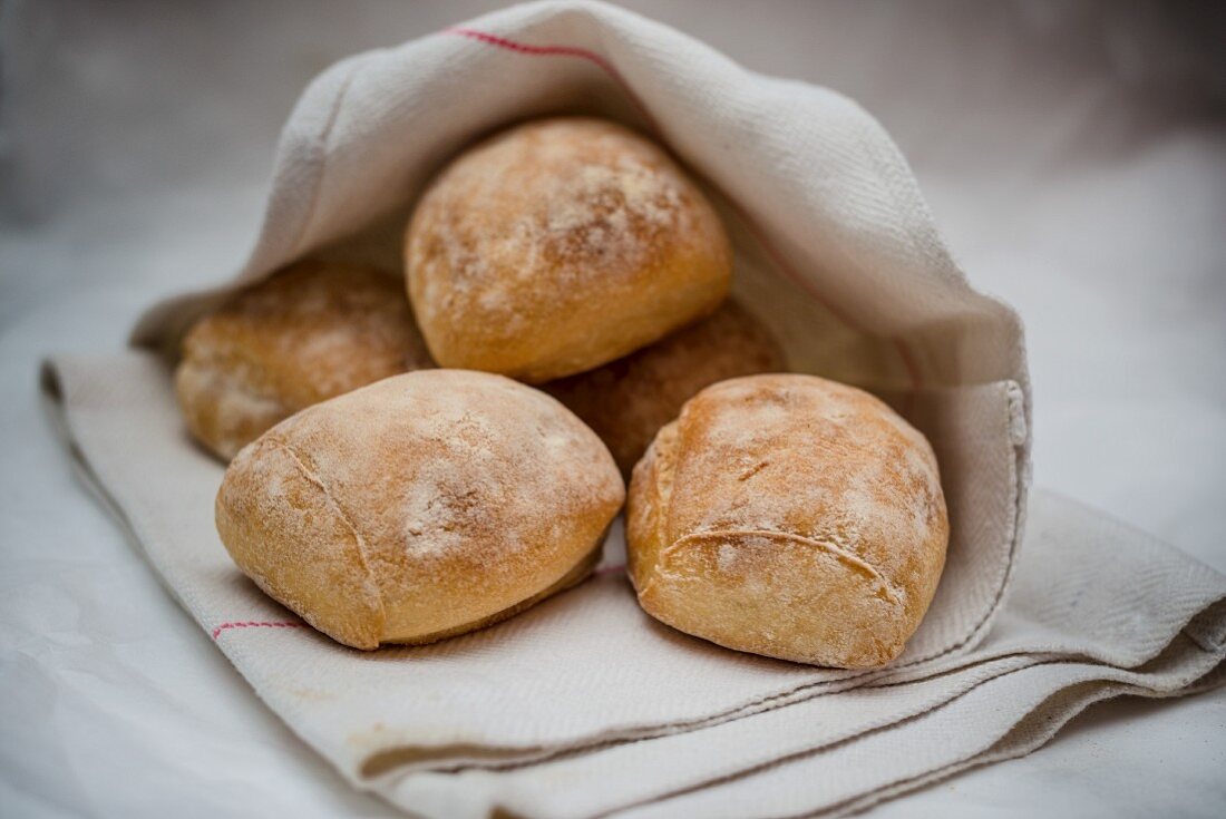 Bread rolls in a tea towel