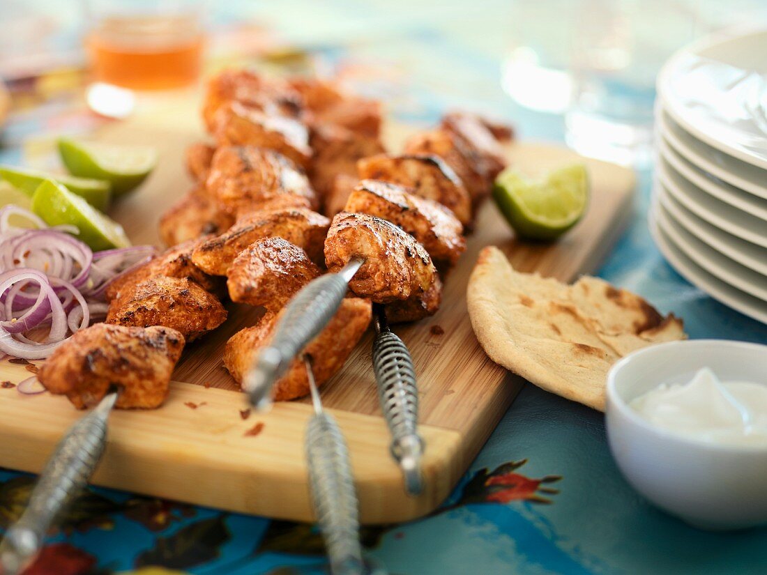 Spicy chicken kebabs with flatbread and lime