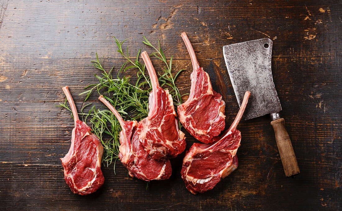Raw fresh meat Veal ribs and Meat cleaver on wooden background
