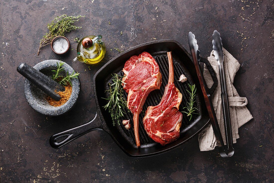 Raw fresh meat Veal ribs for two with ingredients on frying Grill pan