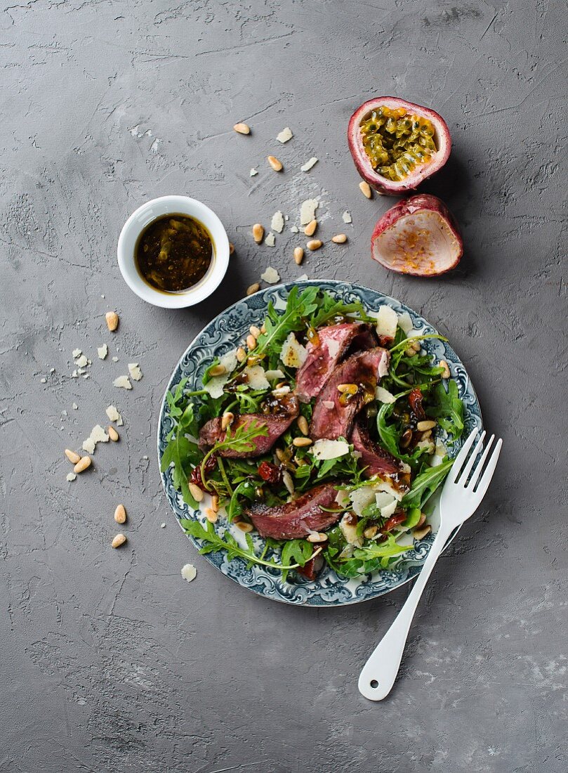 Beef steak with rocket, dried tomatoes and passionfruit & balsamic vinegar dressing