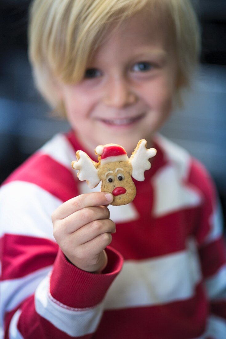 A child with a Christmas biscuit