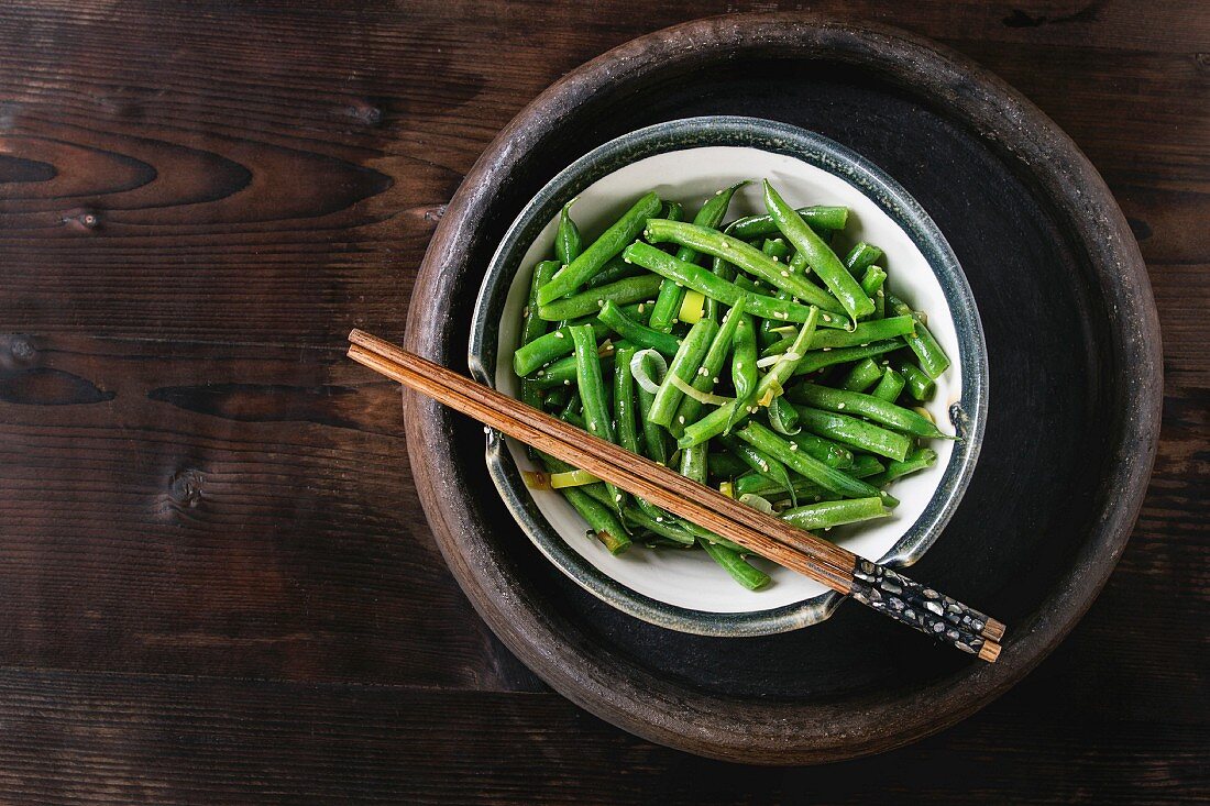 Green beans with onion and sesame seeds in a dish