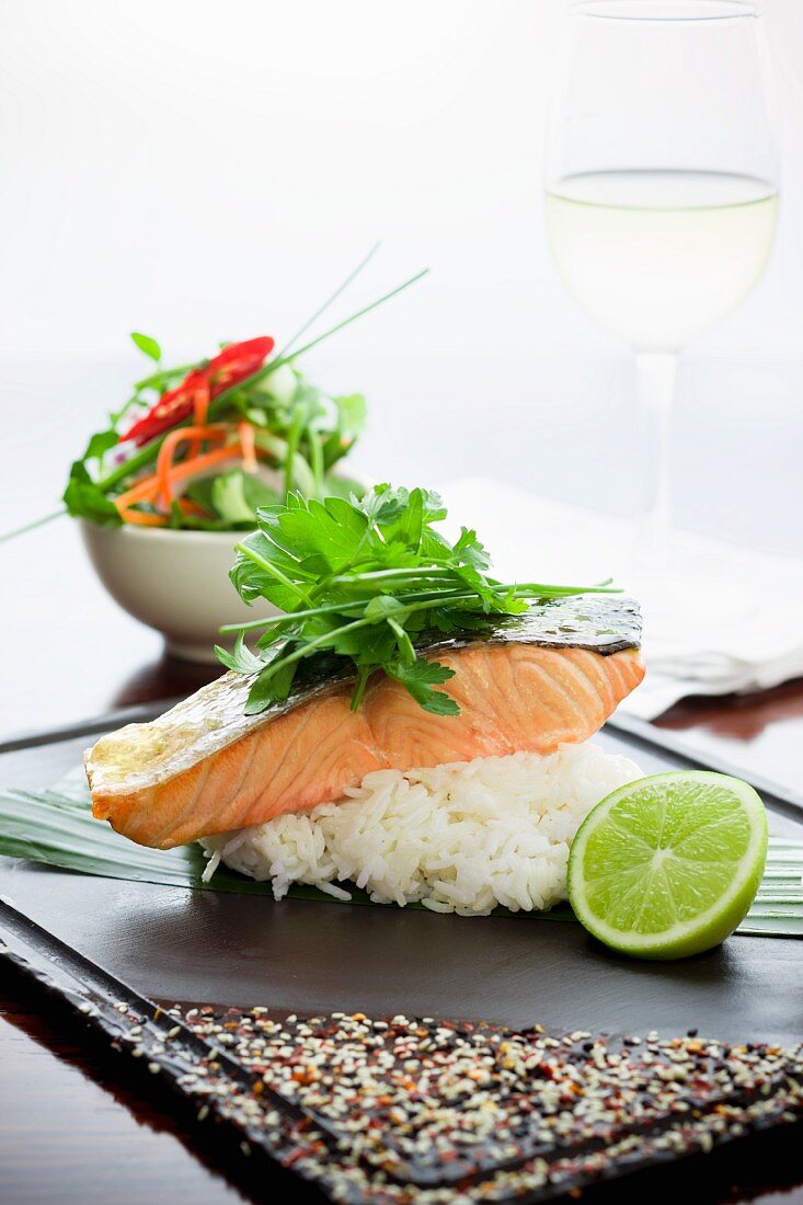 Roast salmon on a bed of rice with lime
